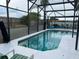 View of the pool featuring a screened-in lanai providing a private and comfortable space for outdoor enjoyment at 340 Haversham Way, Davenport, FL 33897