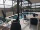 Enclosed pool area with an outdoor seating area for dining and entertainment at 340 Haversham Way, Davenport, FL 33897