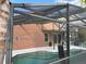 View of the pool area with a screened enclosure and view of the home's exterior at 340 Haversham Way, Davenport, FL 33897