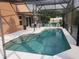 Backyard view of screened-in pool with patio area perfect for entertaining and enjoying outdoors at 340 Haversham Way, Davenport, FL 33897