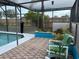 Screened-in pool area with an outdoor patio with seating and views of the water at 340 Haversham Way, Davenport, FL 33897