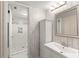 Chic bathroom with a modern vanity, decorative mirror, and a beautifully tiled walk-in shower at 3475 Flossmoor Ave # 103, Orlando, FL 32822