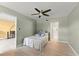 Comfortable bedroom with a ceiling fan, neutral walls, and wood-look tile flooring at 3475 Flossmoor Ave # 103, Orlando, FL 32822