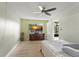 Bedroom featuring a ceiling fan, wood-look flooring, and a window with natural light at 3475 Flossmoor Ave # 103, Orlando, FL 32822