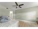 Cozy bedroom with a ceiling fan, light-colored walls, and wood-look tile flooring at 3475 Flossmoor Ave # 103, Orlando, FL 32822