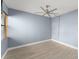 Light and airy bedroom featuring wood-look tile floors, a ceiling fan, and natural light at 3475 Flossmoor Ave # 103, Orlando, FL 32822