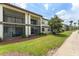Multi-story condo building with manicured lawn, lush landscaping and outdoor patios and balconies at 3475 Flossmoor Ave # 103, Orlando, FL 32822