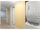 Efficient laundry area featuring a stacked washer and dryer unit for convenient chores at 3475 Flossmoor Ave # 103, Orlando, FL 32822