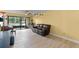 Living room featuring tile floor, piano, comfy sofa, and natural light at 3475 Flossmoor Ave # 103, Orlando, FL 32822