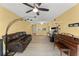 The living room offers tile floors, a ceiling fan, and stylish furnishings at 3475 Flossmoor Ave # 103, Orlando, FL 32822