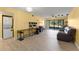 Spacious living room boasts tile floors, modern decor, and sliding door access to a patio at 3475 Flossmoor Ave # 103, Orlando, FL 32822