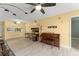 Bright living room featuring tile flooring, a ceiling fan, and an open layout to the kitchen at 3475 Flossmoor Ave # 103, Orlando, FL 32822