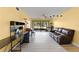 Open concept living room has tile flooring, a ceiling fan, and ample natural light at 3475 Flossmoor Ave # 103, Orlando, FL 32822