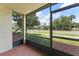 Screened porch with tile flooring and a view of a neatly landscaped street at 3475 Flossmoor Ave # 103, Orlando, FL 32822