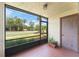 View of the outside from screened lanai, featuring tile floor and neutral walls at 3475 Flossmoor Ave # 103, Orlando, FL 32822