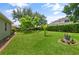 Lush backyard with well-manicured lawn and mature trees on a bright day at 3696 Peacepipe Ct, Clermont, FL 34711
