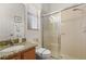 Bathroom featuring a granite vanity, toilet, and enclosed tiled shower at 3696 Peacepipe Ct, Clermont, FL 34711