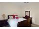 Cozy bedroom featuring a queen-sized bed, dresser, nightstand and neutral decor at 3696 Peacepipe Ct, Clermont, FL 34711