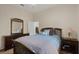 Cozy bedroom with a dresser, nightstand, and an inviting bed with blue bedding at 3696 Peacepipe Ct, Clermont, FL 34711