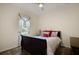 Bedroom with a cozy queen-size bed, decorative pillows, and a ceiling fan at 3696 Peacepipe Ct, Clermont, FL 34711