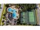 Aerial view of community amenities including a resort-style pool, playground, and sport courts at 3696 Peacepipe Ct, Clermont, FL 34711