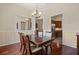 Formal dining room with hardwood floors, decorative molding, and a view into the kitchen at 3696 Peacepipe Ct, Clermont, FL 34711