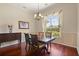 Formal dining room with a charming chandelier and a large window for natural light at 3696 Peacepipe Ct, Clermont, FL 34711
