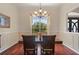 Dining room featuring hardwood floors, decorative molding, and a large window with a backyard view at 3696 Peacepipe Ct, Clermont, FL 34711
