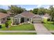 Beautifully landscaped home with a spacious front yard and an inviting exterior at 3696 Peacepipe Ct, Clermont, FL 34711