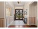 Elegant foyer featuring double doors with decorative glass and tile flooring at 3696 Peacepipe Ct, Clermont, FL 34711