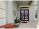 Inviting home entrance featuring double doors with decorative glass and a cozy seating area at 3696 Peacepipe Ct, Clermont, FL 34711