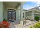 Lovely front entrance with double doors, a well-manicured landscape, and stylish outdoor furniture at 3696 Peacepipe Ct, Clermont, FL 34711