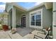 Charming front porch with decorative potted plants, elegant seating, and a welcoming atmosphere at 3696 Peacepipe Ct, Clermont, FL 34711