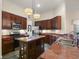 Well-appointed kitchen featuring stainless steel appliances, granite countertops, and custom cabinetry at 3696 Peacepipe Ct, Clermont, FL 34711