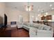 Bright living room with a fireplace and open view to the kitchen's breakfast bar at 3696 Peacepipe Ct, Clermont, FL 34711