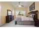 Main bedroom featuring a plush bed, dresser, nightstands, and a bright window at 3696 Peacepipe Ct, Clermont, FL 34711