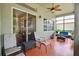 Enclosed porch with decorative tile flooring and comfortable patio furniture at 3696 Peacepipe Ct, Clermont, FL 34711