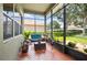 Screened in porch with nice patio furniture overlooking backyard at 3696 Peacepipe Ct, Clermont, FL 34711