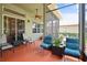 Covered outdoor porch featuring a decorative floor, fan, and patio furniture at 3696 Peacepipe Ct, Clermont, FL 34711