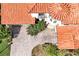 Aerial view showing the home, paver driveway, landscaping, and unique turret architecture at 3844 Bowfin Trl, Kissimmee, FL 34746