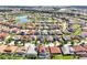 A picturesque community with a tranquil lake, lush landscaping, and a variety of well-appointed homes at 3844 Bowfin Trl, Kissimmee, FL 34746