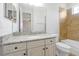 Bathroom with granite vanity, decorative mirrors, and tiled shower and tub combo at 3844 Bowfin Trl, Kissimmee, FL 34746