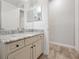 Stylish bathroom featuring a beautiful vanity, marble countertop, and modern fixtures at 3844 Bowfin Trl, Kissimmee, FL 34746