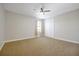 Bright bedroom featuring a ceiling fan, carpeted floors, and a closet with bifold doors at 3844 Bowfin Trl, Kissimmee, FL 34746