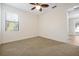 A neutrally decorated bedroom features carpet flooring and a sunny window at 3844 Bowfin Trl, Kissimmee, FL 34746