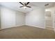 Spacious carpeted bedroom featuring a closet with bifold doors and ceiling fan at 3844 Bowfin Trl, Kissimmee, FL 34746