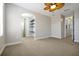 Bedroom with carpet, an arched entry, shelves, and a large window with curtains at 3844 Bowfin Trl, Kissimmee, FL 34746