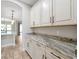 Butler's pantry boasts elegant cabinetry, striking countertops, and seamless access to the kitchen at 3844 Bowfin Trl, Kissimmee, FL 34746