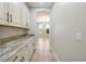 Butler's pantry showcases countertops, and seamless flow to dining area at 3844 Bowfin Trl, Kissimmee, FL 34746