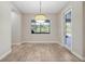 Dining area with large window offering natural light and tile flooring at 3844 Bowfin Trl, Kissimmee, FL 34746